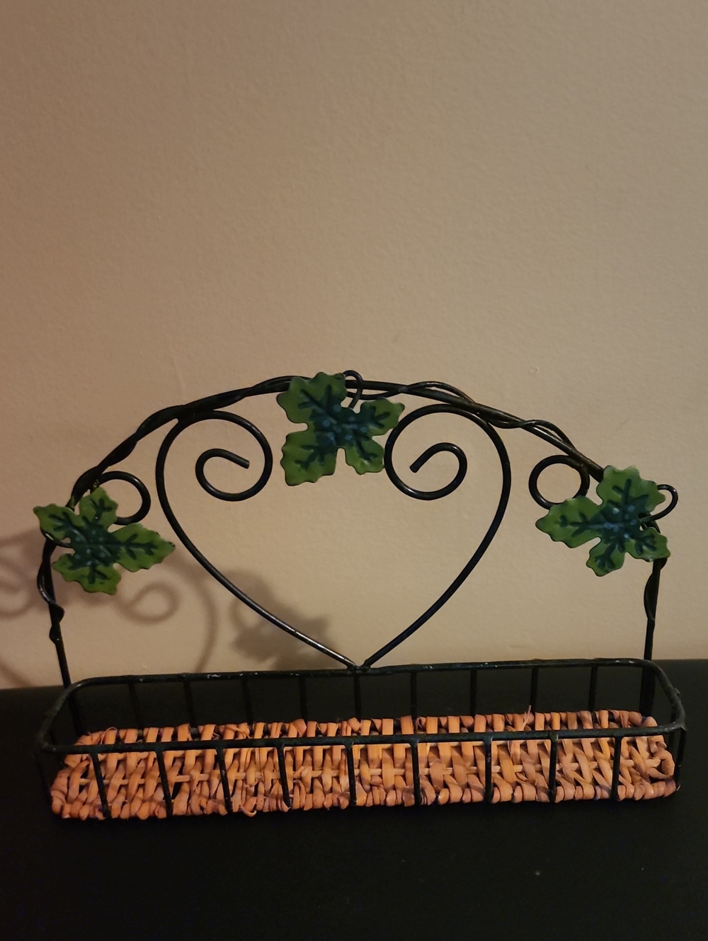 Decorative Black Metal Basket with Green Leaf Accents